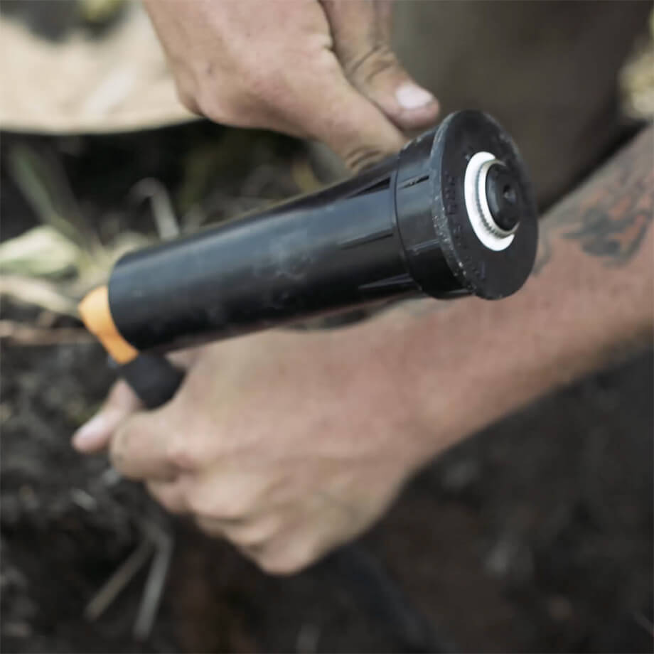 a person performing irrigation maintenance